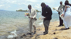 Provincial Governor Cu00e9lestin Kabahizi alongside other local leaders prepare to lay wreaths in water in memory of the Genocide victims. (Photo: S. Nkurunziza)