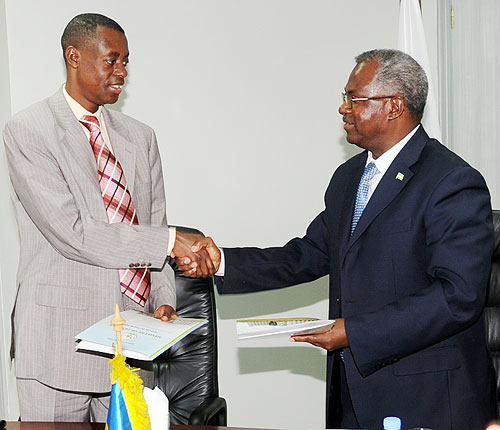 Defence Minister Gen. James Kabarebe (L), and the Minister of Disaster preparedness and Refugees, Gen. Marcel Gatsinzi, shake hands at the handover yesterday. (Photo J Mbanda)