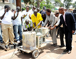 Internal Security Minister, Musa Fazil Harelimana (R), Infrastructure Minister Vincent Karega, Kigali City Mayor Aisa Kirabo Kakira and Commissioner General of Police, Emmanuel Gasana, participate in the repainting of a zebra crossing at the main roundabo