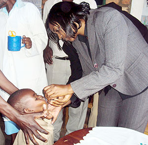 Simbi Dative Mukabaliza, Karongi district vice Mayor in charge of Social Affairs administers a vaccine  to one of the children. (Photo: S. Nkurunziza)