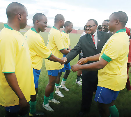 Minister Protais Musoni greets members of the media team at a match to mark the World Press Freedom Day in Muhanga District. (Photo; F. Goodman)