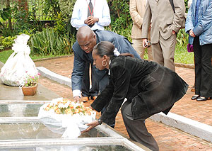 RGCu2019s CEO Philip Brizoua (L) laying flowers on a mass grave at Kigali Memorial Centre, Gisozi. (Photo; S. Butera)