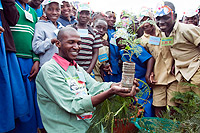 Eric Mutabazi shows the students a seedling of the tree during the exercise (Courtsey Photo)