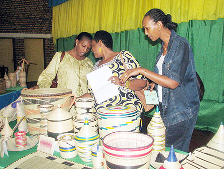 Members of the  panel of judges for the artist competition inspecting some of the items submitted for the competition. (Photo: J.C Gakwaya)