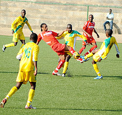 Simbau2019s Kelvin Yondan fights for the ball with Atraco players. Simba won the contest 2-1 to boost their chances of reaching the quarters. (Photo/ F. Goodman)