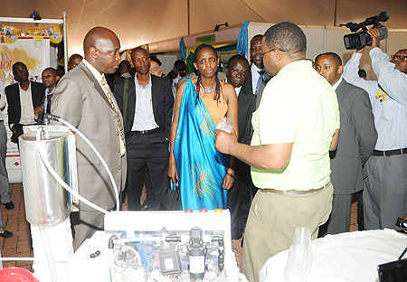 The Minister of Agriculture Dr. Agnes Kalibata viewing the milk dispenser machine at the 6th ESADA Exhibition. Right is Antonio Magnaghi of Lattebox. (Photo; J. Mbanda)