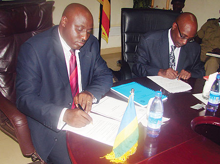 Rwandau2019s Commissioner General of Police, Emmanuel Gasana, and his Ugandan counterpart sign an MoU in Kampala yesterday (Photo: E. Kabeera)