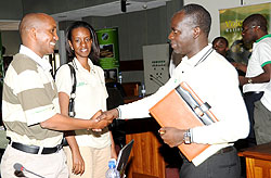 Minister Stanislas Kamanzi (R) greets Volcanoes National Park Chief Warden Prosper Uwingeli as Rica Rwigamba looks on yesterday .(Photo J. Mbanda)