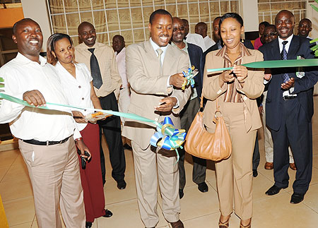 Deputy Commissioner General,Rwanda Revenue Authority Eugene Torero (C) with Molly Rugambwa of the Private Sector, Federation opening the RRA Nyabugogo Branch, on Tuesday (Photo J Mbanda)