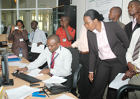 The Director of Business Registration at RDB Yves Sangano explains how online registration is done as Deputy CEO Clare Akamanzi looks on,Monday. (Photo by F. Goodman)