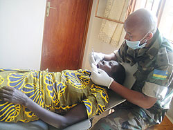 Capt. Jean Bosco Karangwa treating a patient yesterday at Gahanga Health Center as part of the Army Week activities. (Photo: E. Mutara)