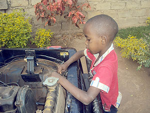 Young Osama Bin Badala trying a motor engine.