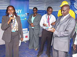 BK Gicumbi Branch Manager, Muhongayire (L) explains the financial benefits extended by the bank to clients during the expo. ( Photo by A.Gahene)