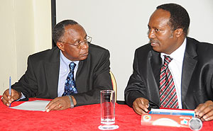 NURC Chairman Bishop John Rucyahana (L) talks to Executive Secretary Jean Baptiste Habyarimana recently. (Photo J Mbanda)