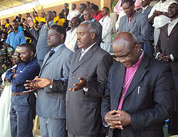 The Minister of Education, Dr. Charles Murigande and  religious leaders join residents to pray for peace during the Monday elections. (Photo D.Sabiiti)