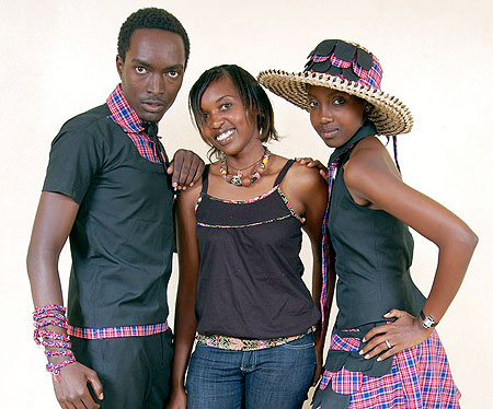 Models pose for a photo shoot with Colombe Ituze Ndutiye (C), who designed the collections.