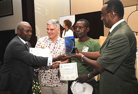 Emmanuel Rwakagara (L) receives an award from PM Bernard Makuza during the Coffee Cup of Excellence ceremony at Serena Hotel yesterday (Photo F.Goodman)