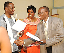 Health Minister,  Dr. Richard Sezibera (L) and Dr.Agnes Binagwaho (C) awarding certificates to the doctors yesterday (Photo T.Kisambira)