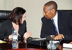 Minister of Finance John Rwangombwa (R) talks to the Head of DFID in Rwanda Elizabeth Carriere at the press conference recently (File photo)