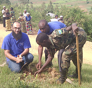 Tigo officials joined by an RDF officer during the tree planting exercise on Monday (Courtsey Photo)