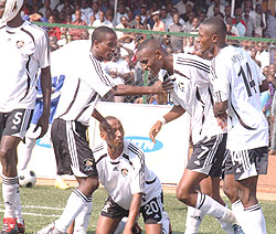 Migi is mobbed by his teammates during a past league game. The midfielder scored APR's winner on Saturday.(File Photo)