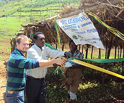 AVSI's Calvi Guido and Ildephonse Rwayitare of Rotary Club Kigali cutting the tape to launch the plantation of trees in Muhura (Photo; D. Ngabonziza)