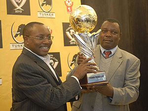 Cecafa Secretary General Nicholas Musonye (right) receiving this year's Cecafa Challenge Cup trophy. (Courtesy photo)