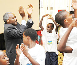 Education Minister, Charles Murigande, joins children in song and dance during the children summit in Kigali yesterday (Photo; T. Kisambira)