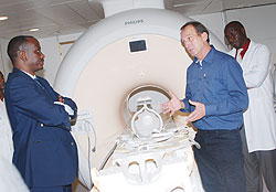 One of the German doctors (r) who is in the country to train Rwanda radiologists in the use of the MRI explains to Dr Sezibera  about the newly acquired equipment (Courtesy photo)