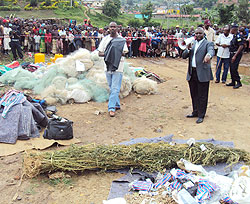 Fiacre Nyamuhenda, the Chief Prosecutor at Karongi Intermediate Court addressing residents shortly before destroying the illicit  items (Photo; S. Nkurunziza)