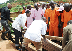 Commissioner General of Prisons Mary Gahonzire (2 left) with other officials join prisoners and residents in the repair of a bridge in Gasabo District