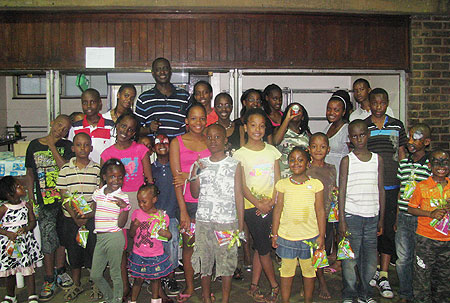 Envoy Ignatius Kamali in a group photo with Rwandan children living in South Africa (Courtesy Photo)