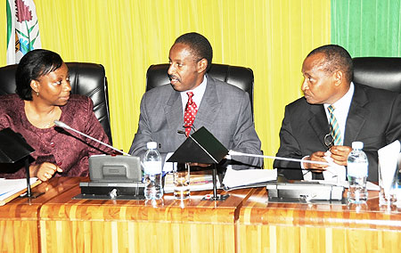 The Executive Secretary the National Human Rights Commission Sylvie Zainab Kayitesi (L) consults Commissioners Deogratias Kayumba (C) and Pierre Karemera in Parliament yesterday. (Photo