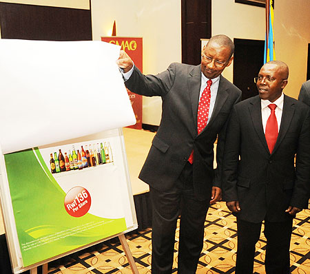 Minister of Finance, John Rwangombwa, unveils the Bralirwa IPO as Robert Mathu the Executive Director of capital markets look on. 