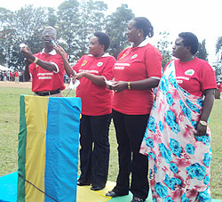 Hon. Theobald Mporanyi and other Members of Parliament, demonstrating to the residents how to use a condom (Photo; A. Ngarambe)