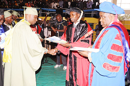 The State Minister for Primary and Secondary Education, Mathias Harebamungu, (C) awarding certificates at the graduation ceremony, yesterday. (Photo: J. Mbanda)