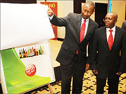 Rwandau2019s Minister of Finance John Rwangombwa unveils the Bralirwa IPO as Robert Mathu the Executive Director of Capital Markets Advisory Council  looks on(File Photo )