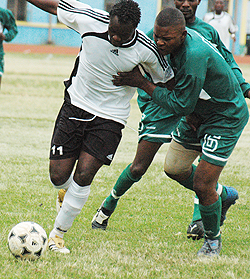 APR's Joseph Bwalya (L) tries to get past a Kiyovu defender during the 2006 national football league. (File Photo)