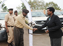 Commissioner General of the National Prison Service, Mary Gahonzire (R), hands over the newly acquired vehicles to Prisons Directors. (Photo J Mbanda)