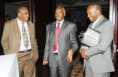 Education Minister, Charles Murigande (C) talks to the Principal of Nyanza Vocational Training Centre (Kavumu), Gideon Rudahunga (L), and Workforce Development Authority Chairman, John Bideri, at the opening of the TVET Symposium on Monday. (Photo J Mband