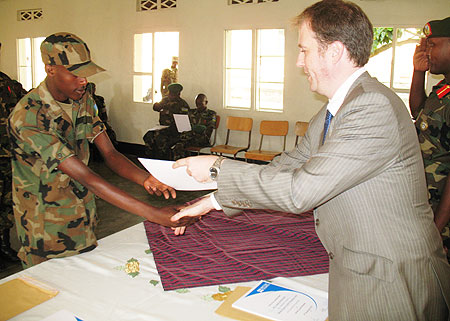 Michael Bibby British council Manager Programmes Rwanda handiing over the certificate to one of the RDF officers yesterday (Courtesy Photo)