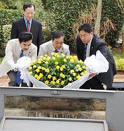 (L-R) MPs, Sato Masayoshi, Yanagisawa and Yonenaga Harunobu laying a wreath at Gisozi, yesterday, as Kunio Hatanaka, the Japanese envoy looks on. (Photo B. Asiimwe)