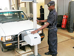 A Policeman checks a vehicle at the Technical control centre in Remera.