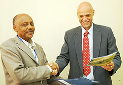 RARDAu2019s Dr. Theogene Rutagwenda with Jan Delbaere of WFP after the signing yesterday (Photo / T. Kisambira)