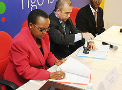 Sharon Haba the PS Of MINEDUC and Marcelo Aleman the CEO of Tigo signing the MOU (Photo T.Kisambira)