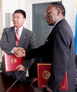 Foreign Ministry PS, Eugene Munyakayanza and Chinese diplomat Li Yigang after the signing yesterday (Courtsey Photo)