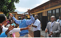 Dr. Mathias Harebamungu joins the residents in celebrating the 90 classrooms in Kamonyi district (Photo; D. Sabiiti)