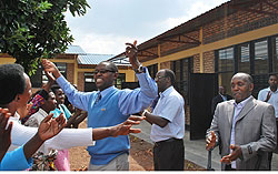 State Minister for Primary  and Secondary Education, Dr Mathias Harebamungu, joins  residents in celebrating construction of the 90 classrooms in Kamonyi district. (File Photo)