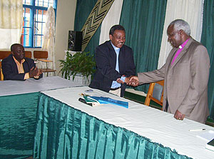 Bishop Rwaje (left) congratulates the new Bishop of Byumba Diocese Emmanuel Ngendahayo as Mayor Nyangezi looks  on. (Photo  / A. Gahene)