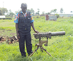 Sgt Philip Musabyimana standing next to one of the weapons he defected with (Photo /A. Ngarambe)